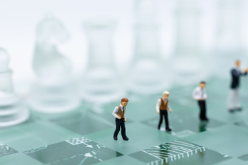 Miniature people, Group Businessmen standing on the chess game, thinking solution for the business game,  use as a business competition concept.