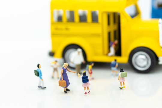 Miniature people : Children,students going to school with school bus by parent. Image use for back to school, education concept.
