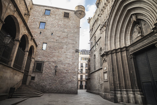 Old street in medieval gothic quarter, door entrance cathedral of Barcelona.