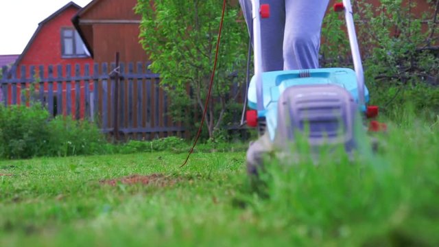 Girl Mowing The Lawn