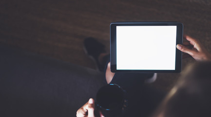 Hipster girl using tablet technology in home, blogger girl person holding computer with blank screen on background bokeh, female hands texting on relax holiday, mockup templates gadget