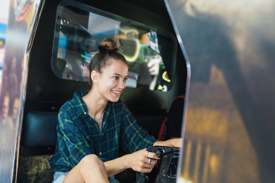 Woman playing arcade machine