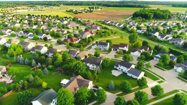 Serene, idyllic neighborhoods, homes, Summertime aerial view, early morning.