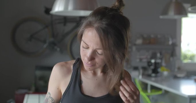 young tattooed relaxed sporty woman portrait at home. .Living room domestic training. 4k slow motion video