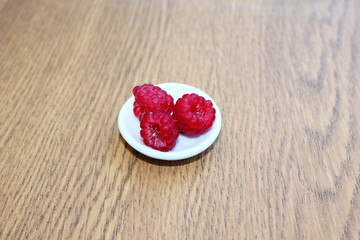  Raspberries on a white plate