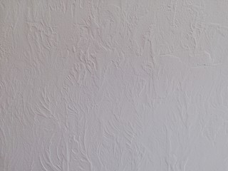 Texture of decorative plaster on the basis of small strokes on a stone wall and acrylic adhesive...