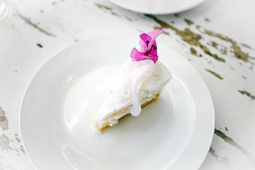 Homemade coconut cake garnish with pink flower