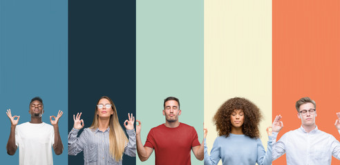 Group of people over vintage colors background relax and smiling with eyes closed doing meditation gesture with fingers. Yoga concept.