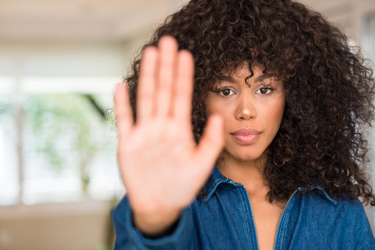 African american woman with open hand doing stop sign with serious and confident expression, defense gesture