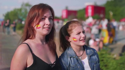 Girls worry while watching football match in fan zone