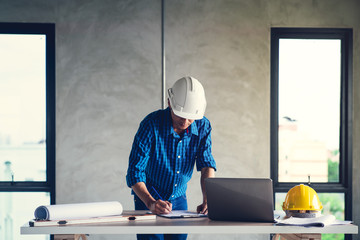 Architect & Engineer working drawing document about project planning and progress of work schedule...