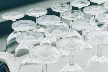 the empty wine glasses on tray prepared for party, selective focus