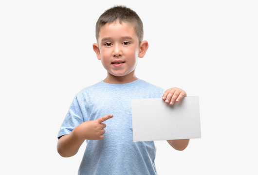 Dark Haired Little Child Holding A Blank Card Very Happy Pointing With Hand And Finger