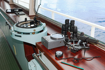 Marine navigation instruments on the bridge of ship at sea: sextant, chronometer, navigation map...