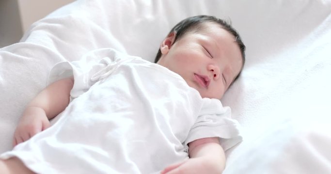 New born baby sleep on bed