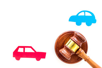 Car accident lawsuit concept. Two collided cars near judge gavel on white background top view copy...