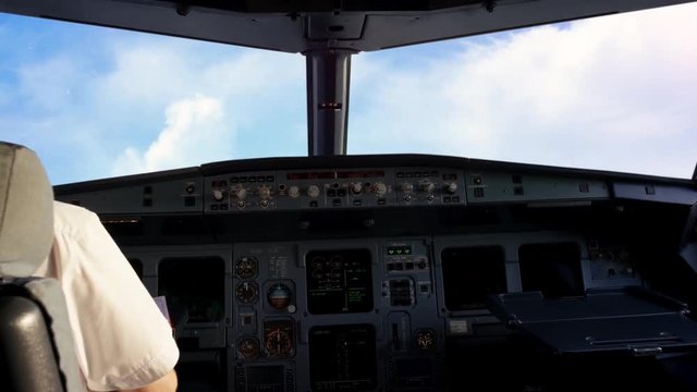 In cockpit, airplane flying over the clouds. View from the cockpit in the sky during the flight