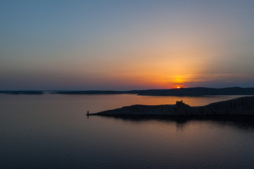 Sunset over turn of a fortress on the Croatian coast
