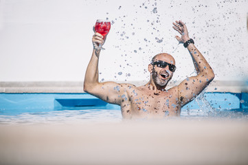 attractive man indoors pool with drink