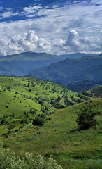 Fototapeta na wymiar Mountain green range in clouds landscape