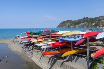 Fototapeta na wymiar Colourful Canoes for rent at the harbor in the town of lavanto on the outskirts of Cinque Terre National Park (Parco Nazionale delle Cinque Terre)