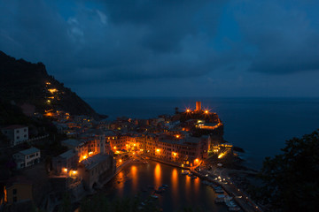 Fototapeta premium Nightime view of the beautiful seaside of Vernazza village in summer in the Cinque Terre area, Italy