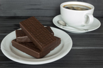 in a white dish, chocolate wafers and coffee
