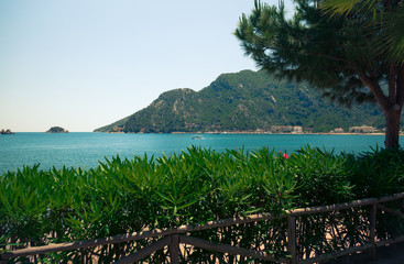 Fototapeta na wymiar View from the green coast to the sea bay
