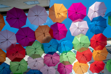 Fototapeta na wymiar Multi-Coloured Street Umbrellas hanging in Carcassonne. South France. Summertime. 