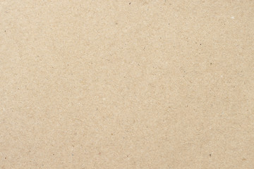 Cardboard, beige paper texture cardboard background close-up, surface with small inclusions of cellulose