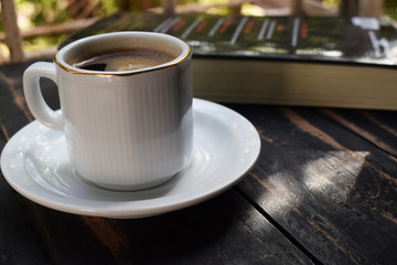 morning hot coffee on the table near the book