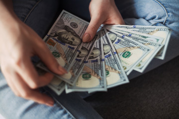 Closeup of woman hands counting new 100 US dollar banknotes