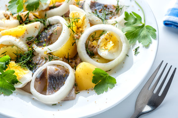 Potatoes with herring, eggs and spices