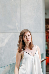 Portrait of pretty woman. Fashionable  woman in shopping centre. Close up portrait of beautiful face of young smiling woman