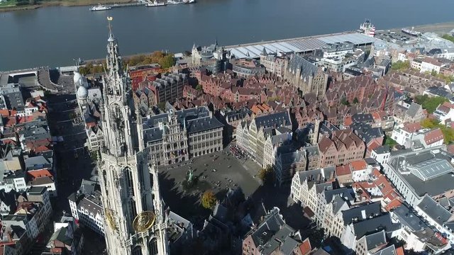 High altitude aerial footage of Antwerp City center showing Onze-Lieve-Vrouwekathedraal the Grote Markt Great Market Square the Brabo Fountain the City Hall the Guildhouses and Scheldt River 4k