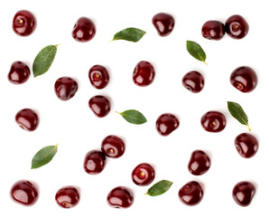 Red cherries and leaves scattered on a white, top view. Fruit background.