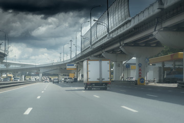 highway junction at the middle of the day. Dark heavy clouds