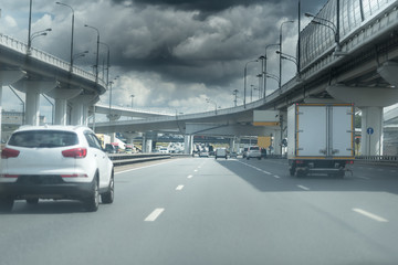 highway junction at the middle of the day. Dark heavy clouds