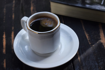 morning hot coffee on the table near the book
