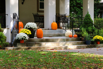 Seasonal house outdoor decoration. Main entrance stair and porch of the stylish house decorated for autumn holidays season. Halloween concept. Fall background.