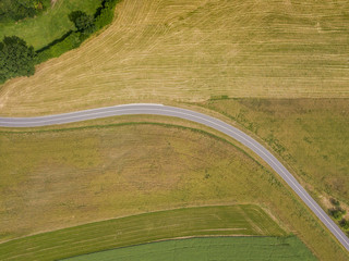 Fototapeta na wymiar Aerial view of road through fields