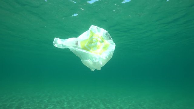 Underwater pollution a plastic bag adrift in the Mediterranean sea below water surface, Almeria, Andalusia, Spain
