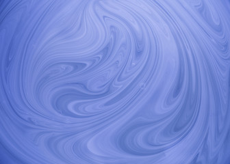 Abstract swirls of white and blue paint 