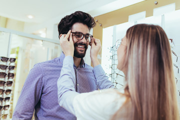 Ophthalmologist doing a visual examination for a customer at an optical center.