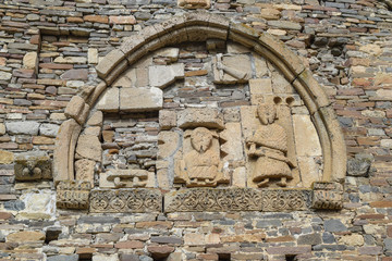 part of the wall decorated with ancient drawings made by hand