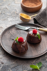 Chocolate fondant lava cake with raspberries and mint. Copy space.