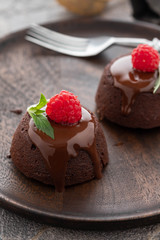 Chocolate fondant lava cake with raspberries and mint. Copy space.