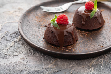 Chocolate fondant lava cake with raspberries and mint. Copy space.