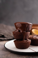 Chocolate brownie with chocolate syrup on wooden black background.Copy space.
