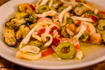 Ceramic plate with the different sea food and olives